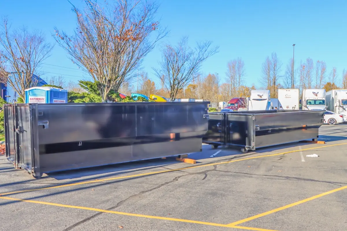 Professional dumpster rental service with roll-off container on residential driveway in Mercer Island